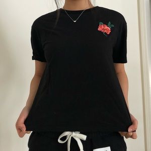 black tee with embroidered rose patch